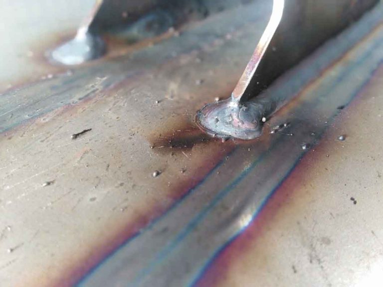 Weld joint and spatters close up after welding in shielding gas