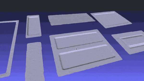 3D render of several light-gray plastic panels and trim pieces laid out on a blue gradient surface.